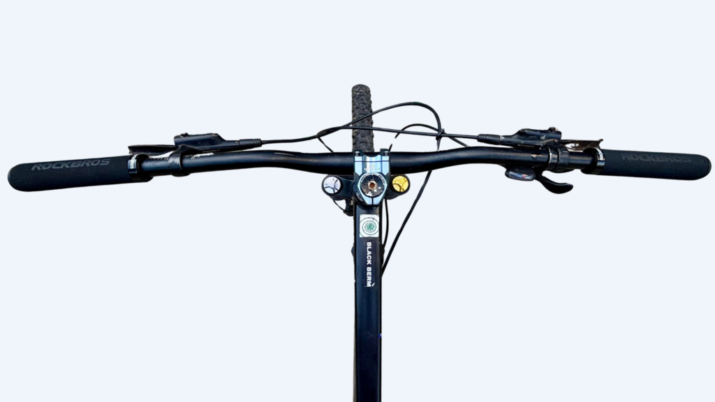 POV view of a rider holding a Rockbros foam handlebar grip on a mountain bike trail in India.